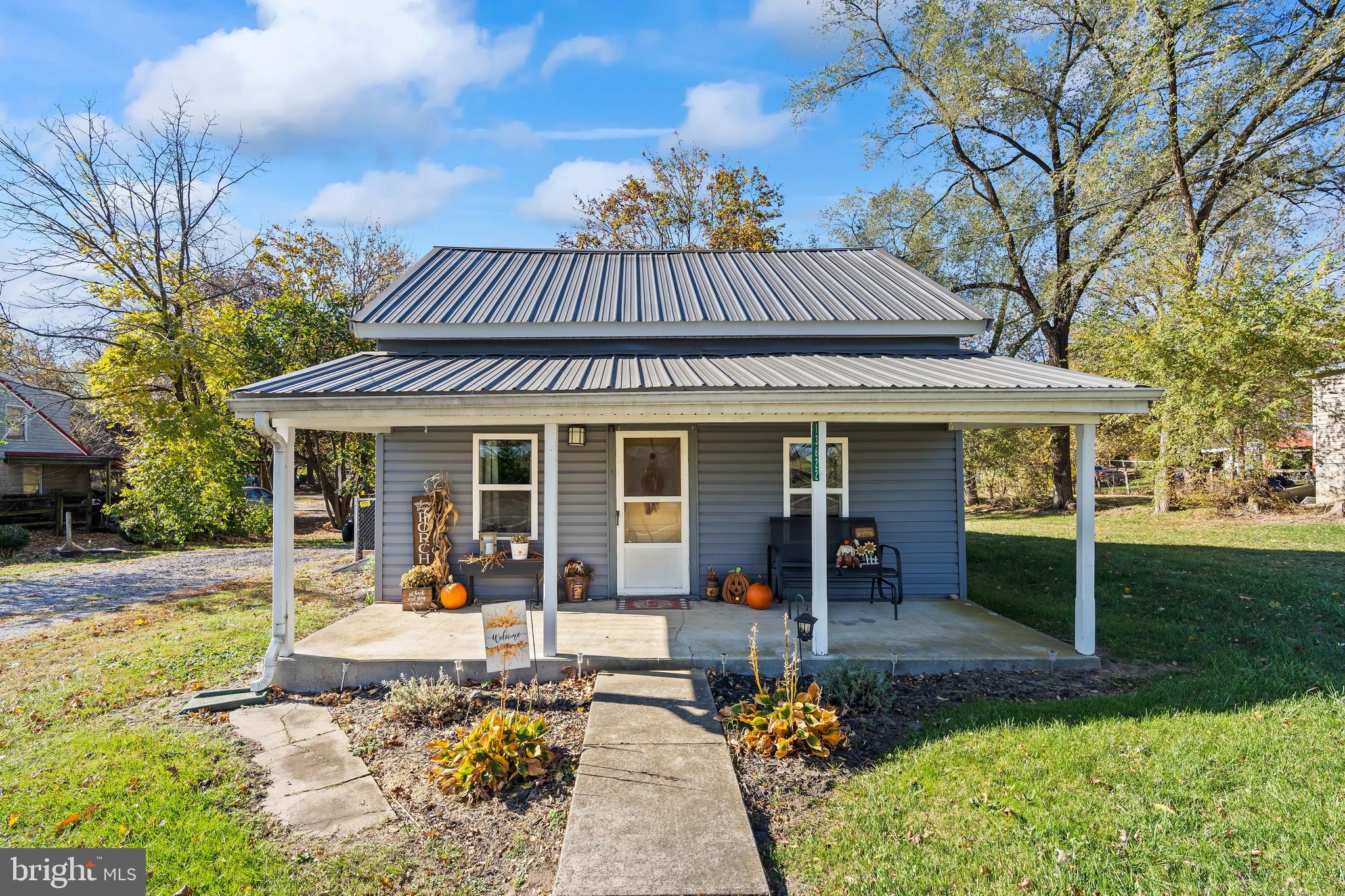 a view of a house with backyard sitting area and garden