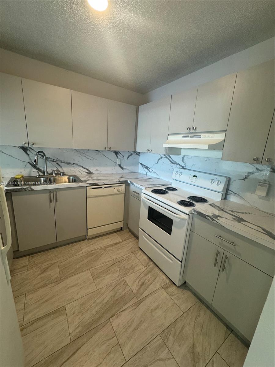 a kitchen with a sink cabinets and appliances