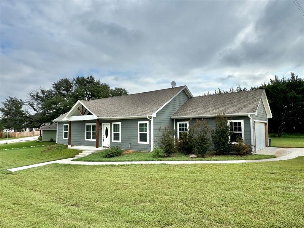 a front view of house with yard and green space