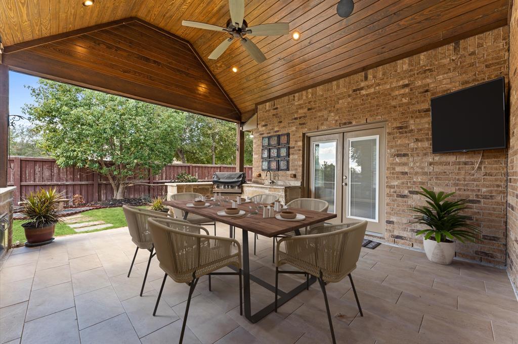 The generous space in this exquisite patio with outdoor kitchen seamlessly blends indoor and outdoor living, offering a luxurious and comfortable setting for any occasion.