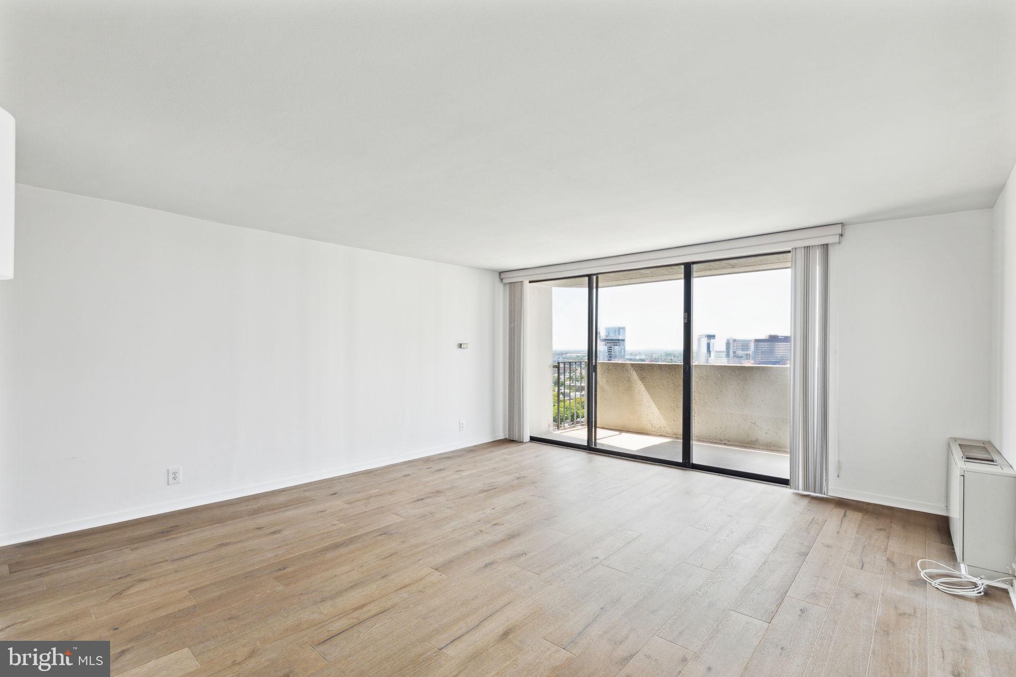 an empty room with wooden floor and door