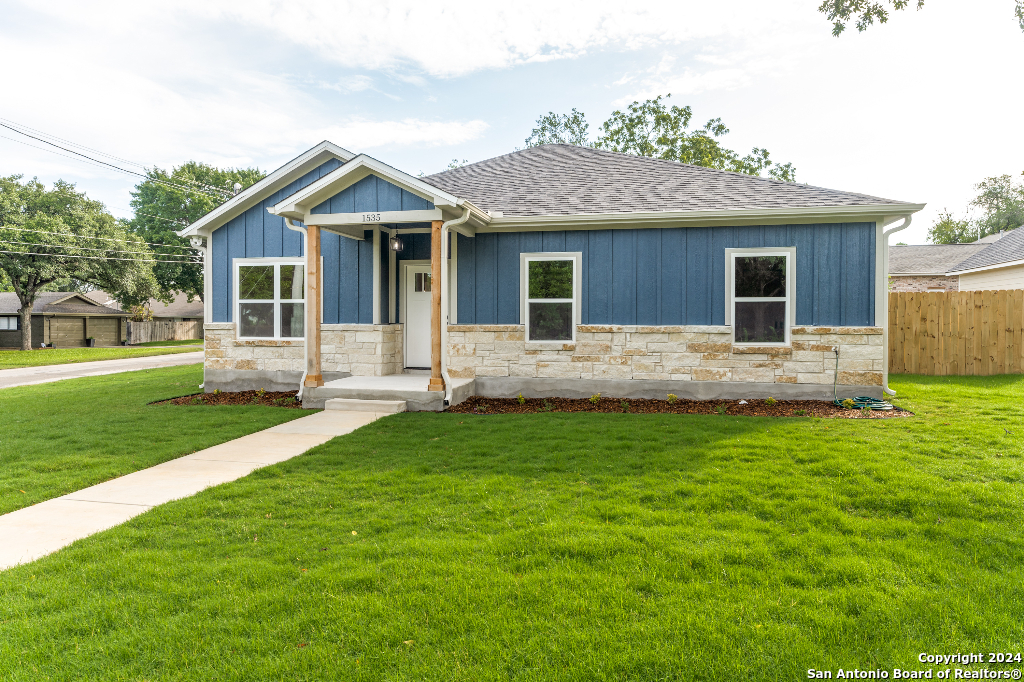 a front view of house with yard and green space