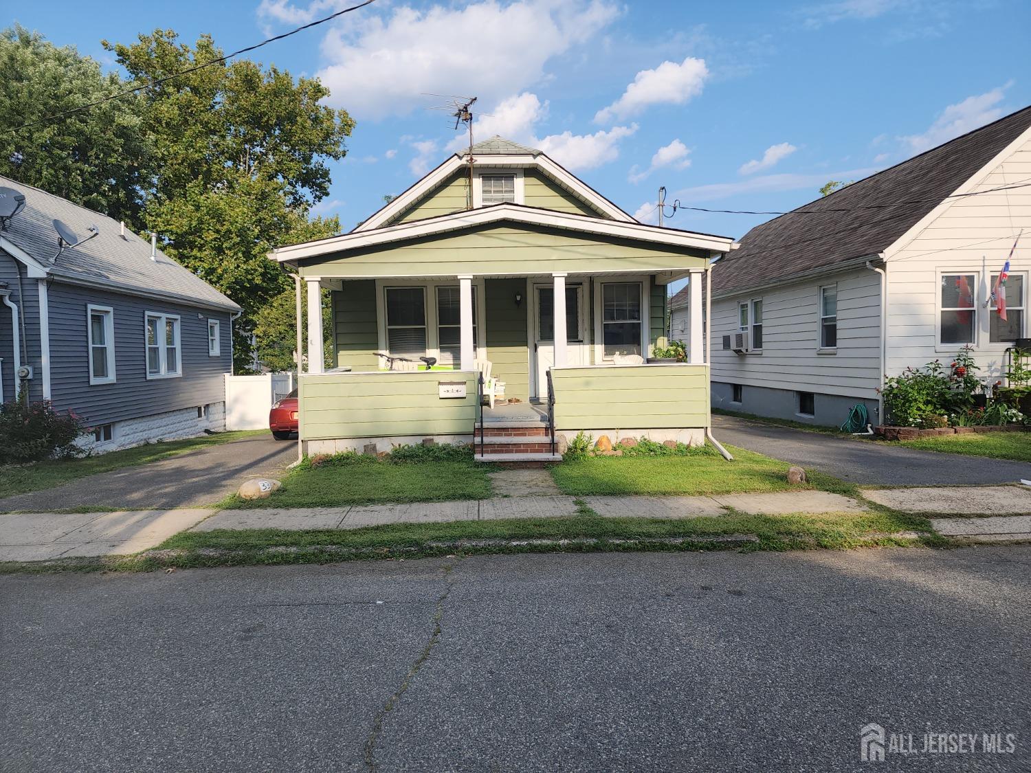 a front view of a house with a yard and outdoor seating