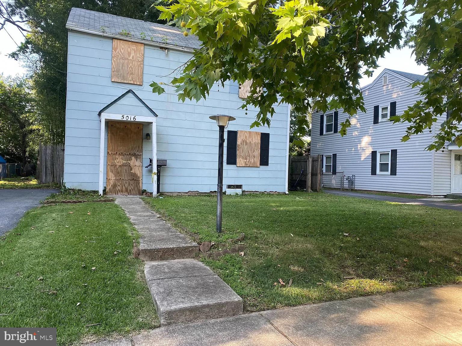 a front view of a house with a garden and yard