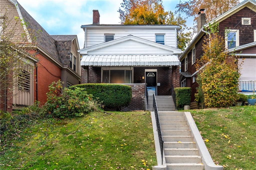 a front view of a house with a yard