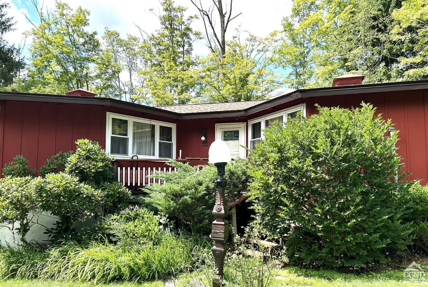 front view of a house with a garden