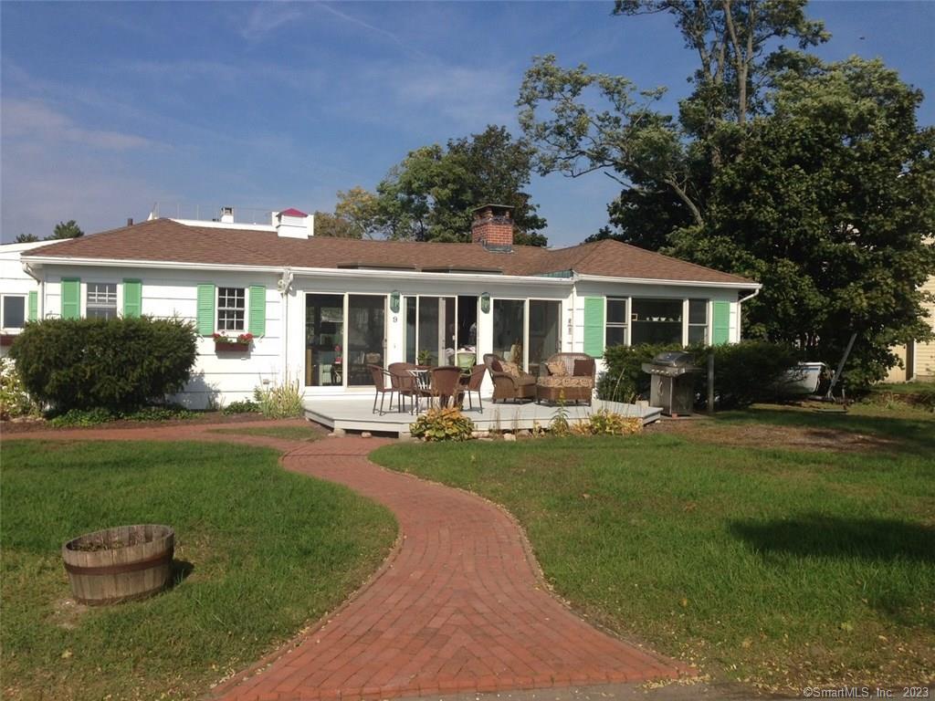 a front view of a house with a yard table and chairs