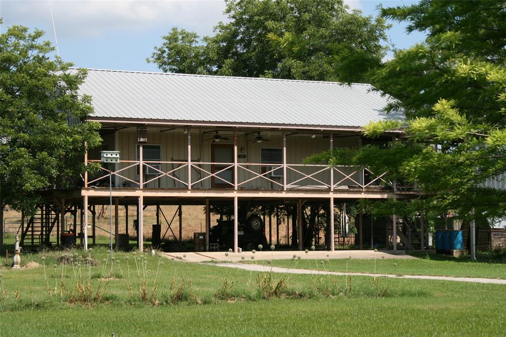 a view of a house with a yard and plants