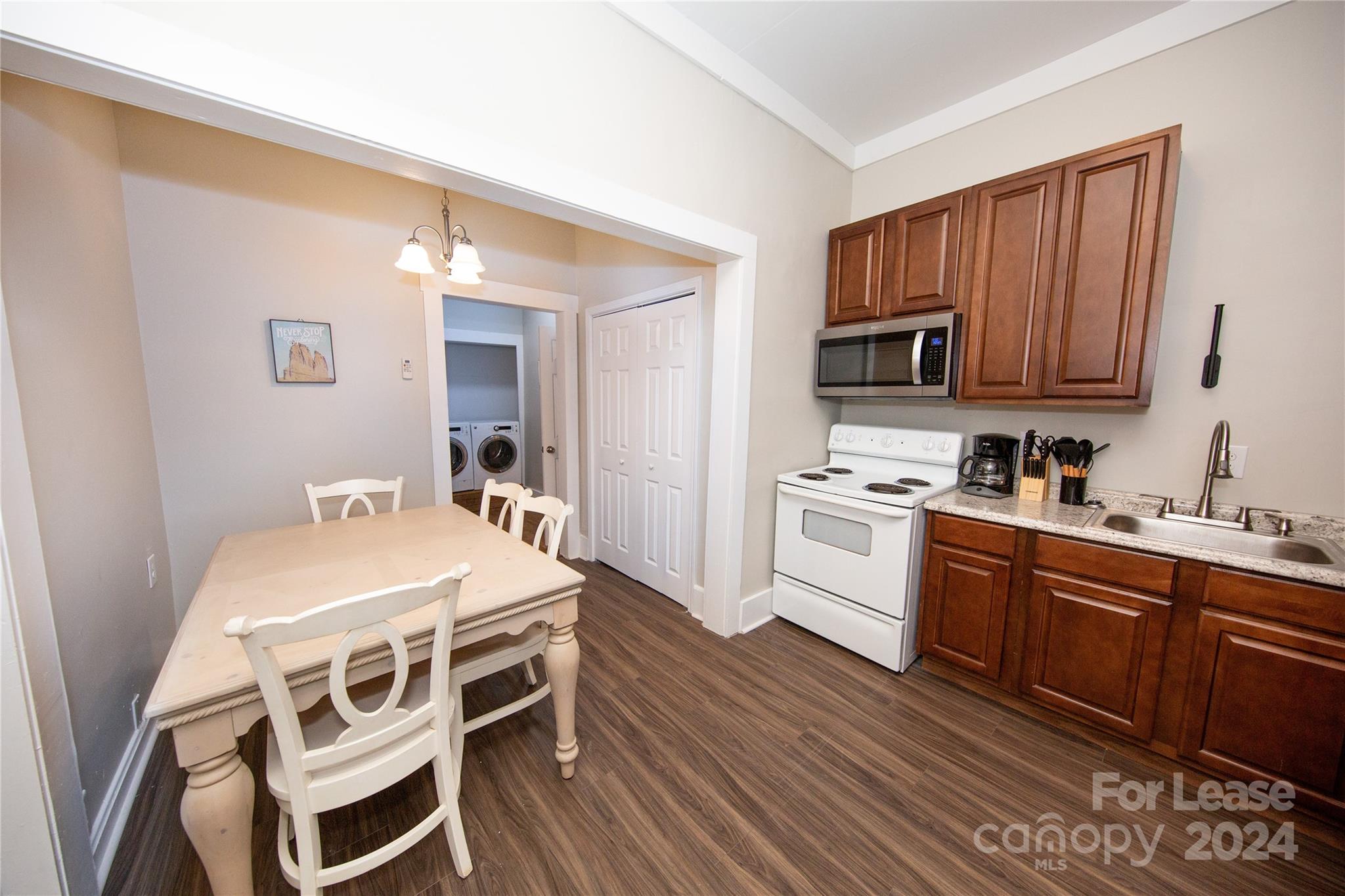 a kitchen with a stove a sink and a refrigerator