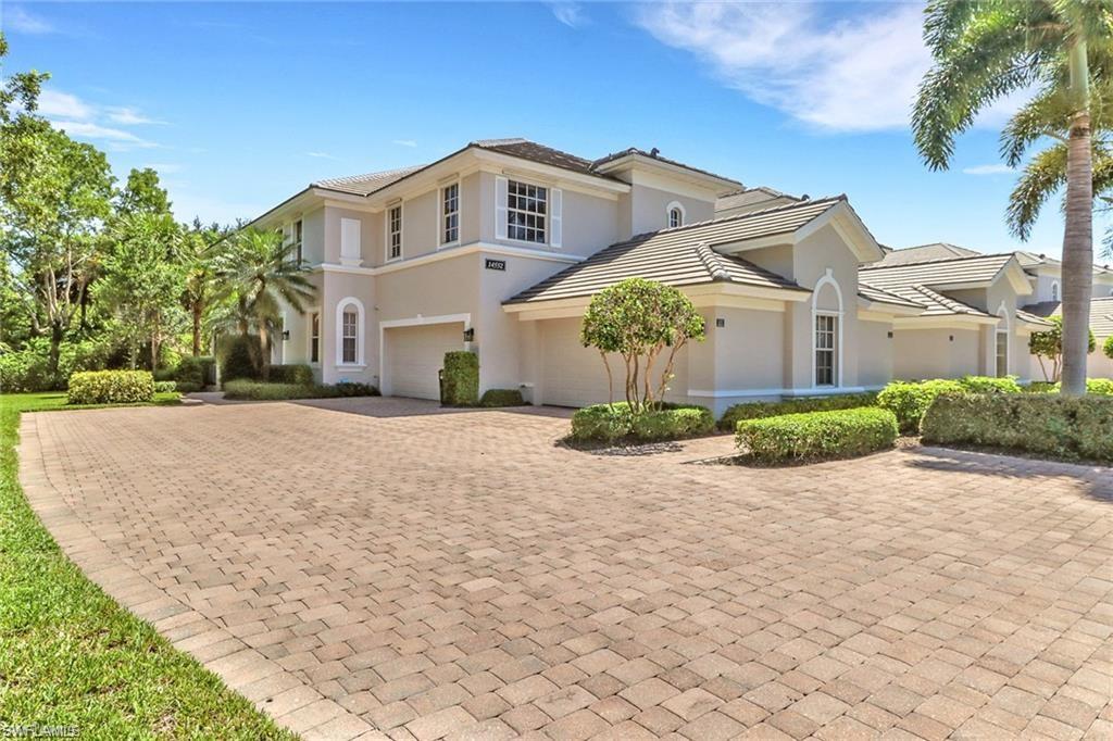 a front view of a house with a yard and a garage