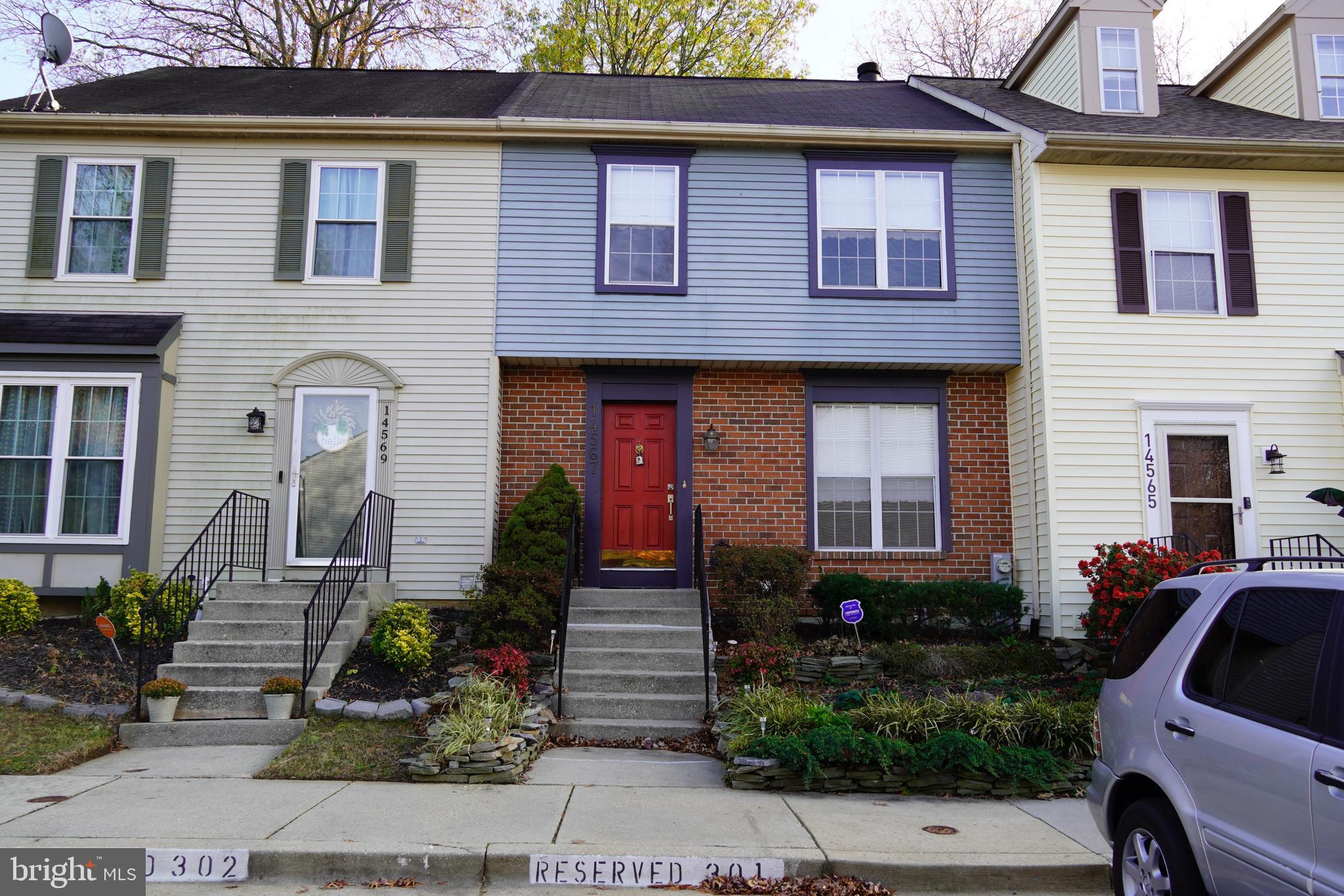 a front view of a house with plants