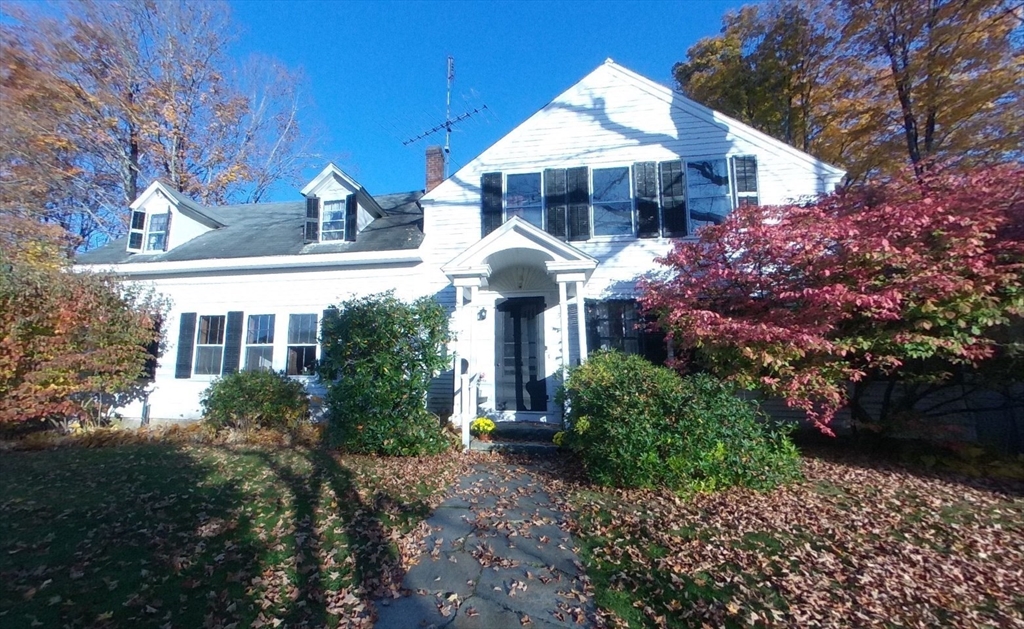 a front view of a house with a yard and fountain