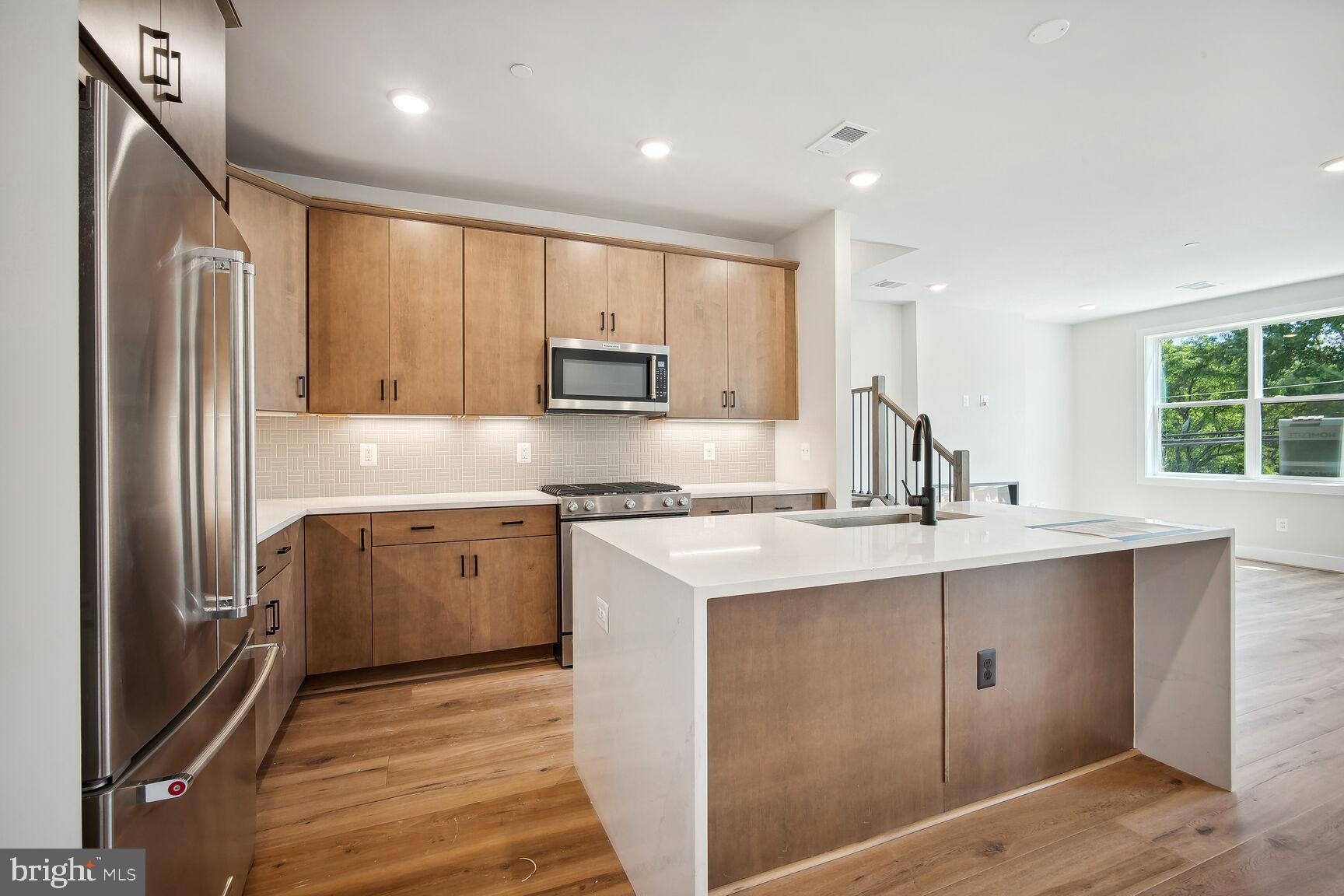 a kitchen with a sink stove and refrigerator