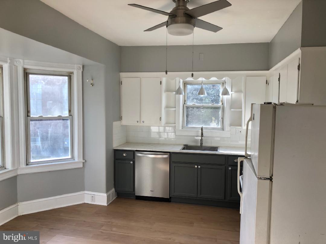 a kitchen with stainless steel appliances a sink and a refrigerator