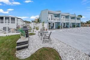 a building outdoor space with patio furniture and garden