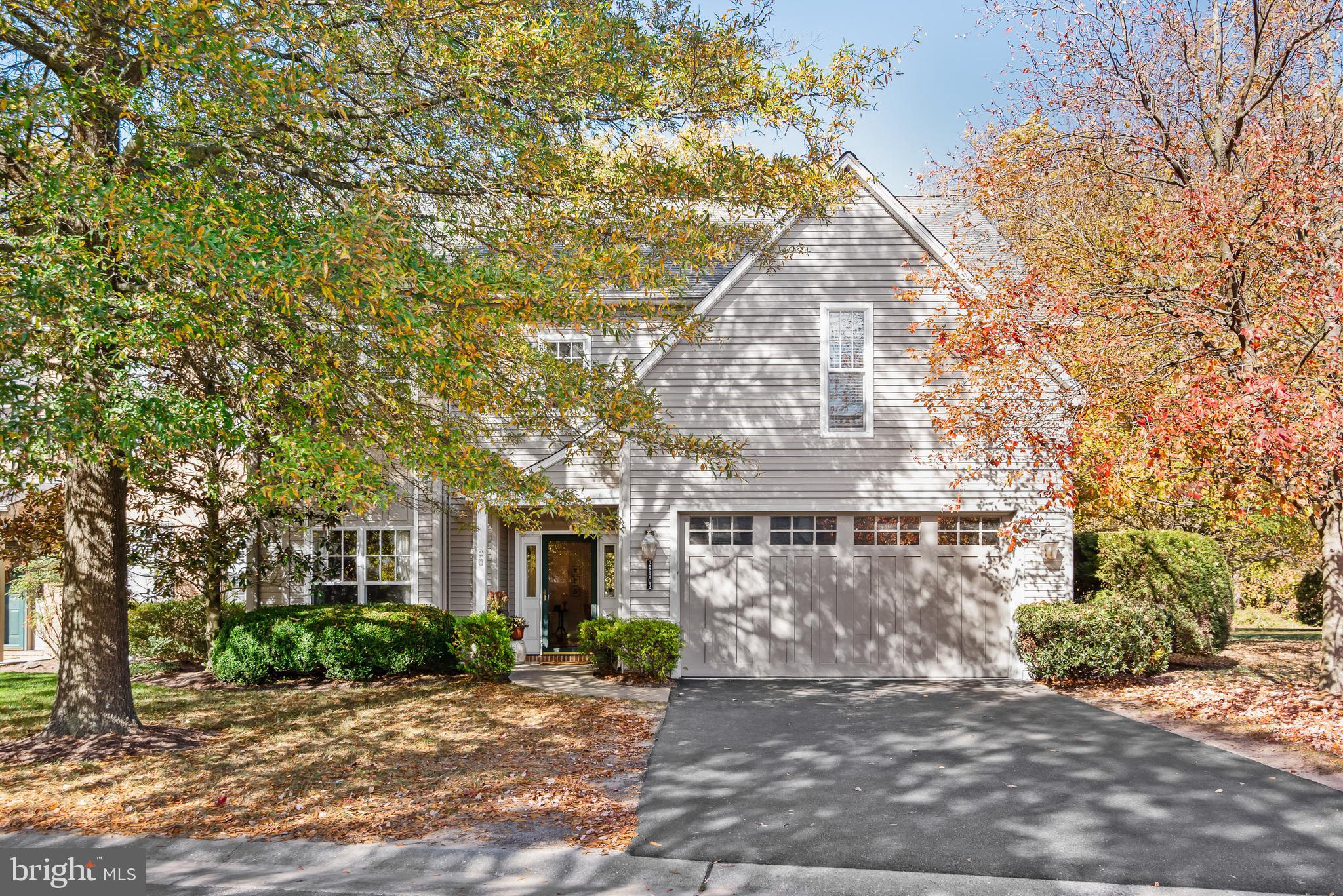 a view of a grey house with a yard