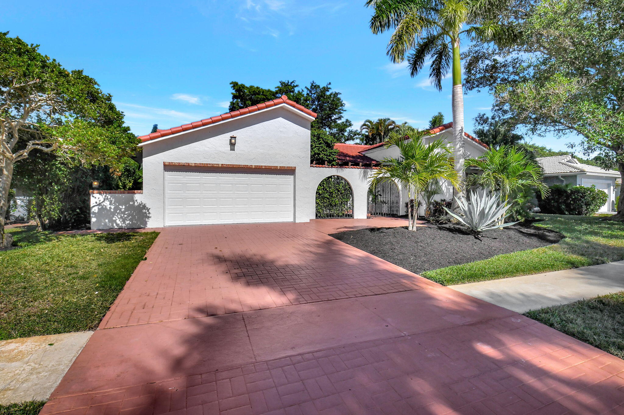 a front view of a house with a yard and a garage