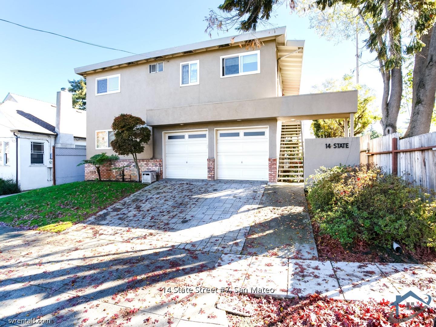 a front view of a house with a yard and a garage