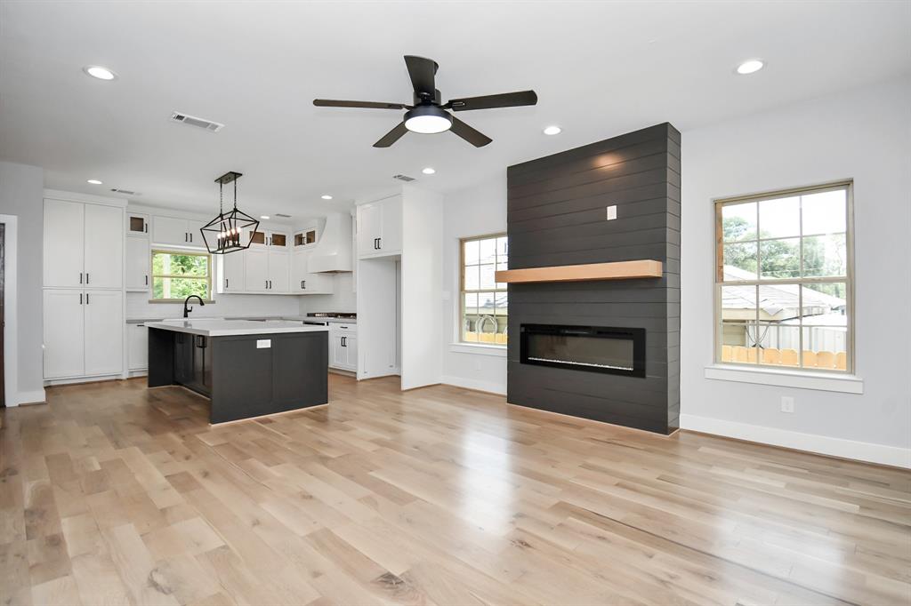 a view of kitchen with a sink and a fireplace