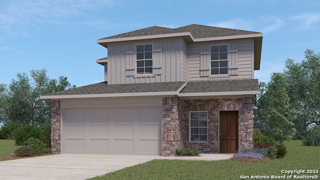 a front view of a house with a garden and garage