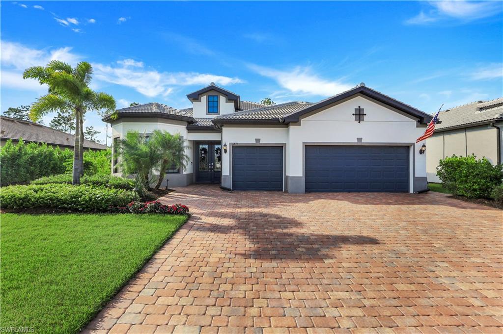 a front view of a house with a yard and a garage