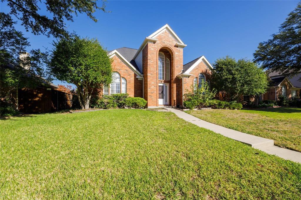 a front view of house with yard and green space