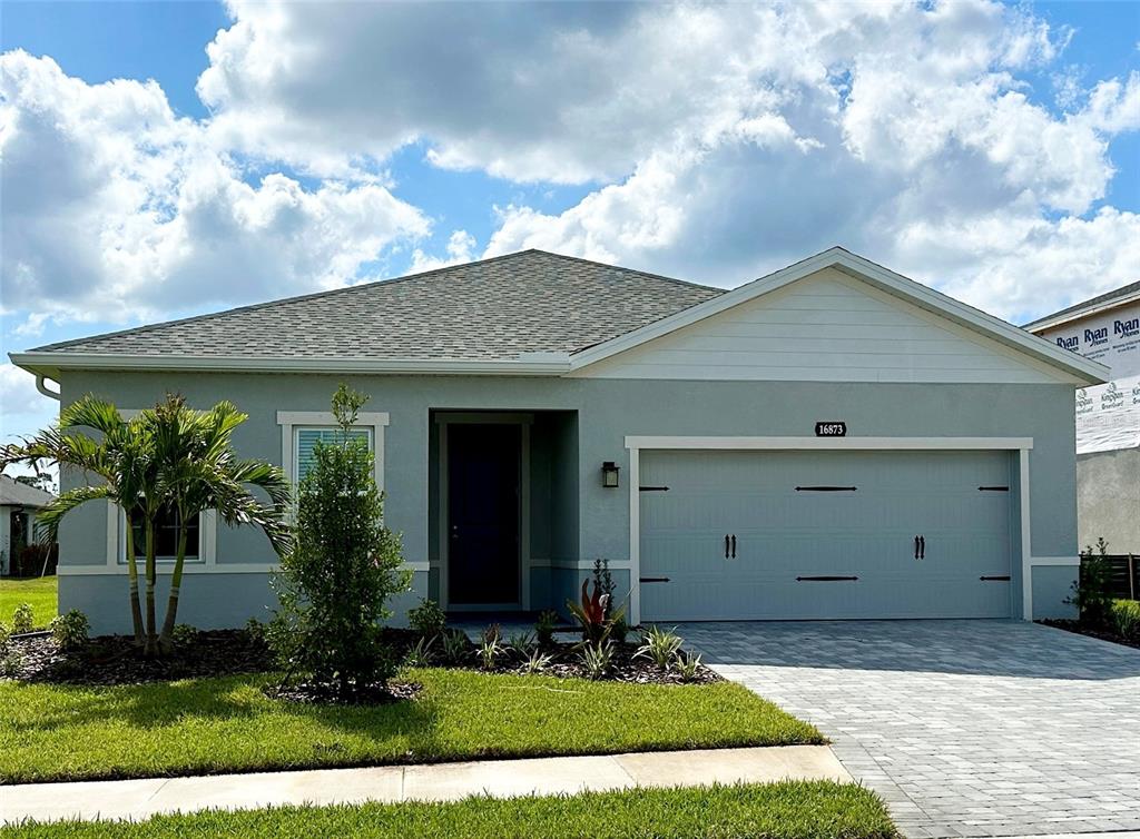 a front view of a house with garden