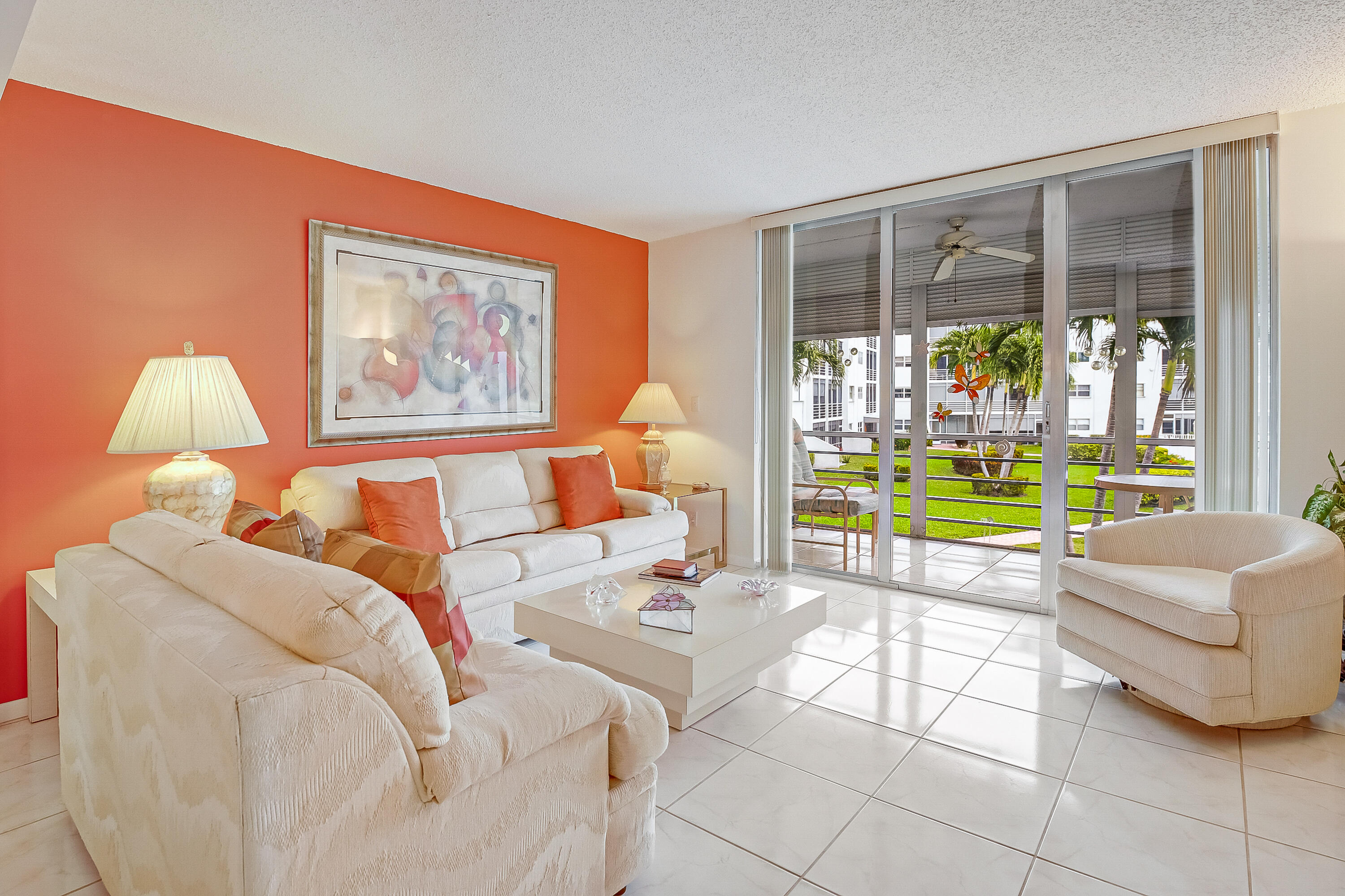 a living room with furniture and a floor to ceiling window