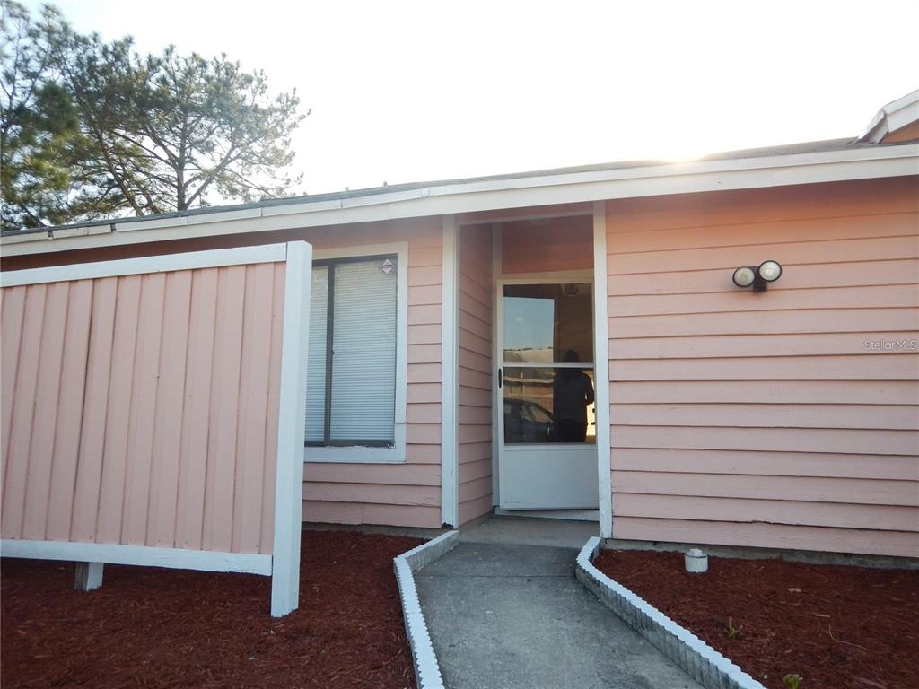 a view of front door and yard