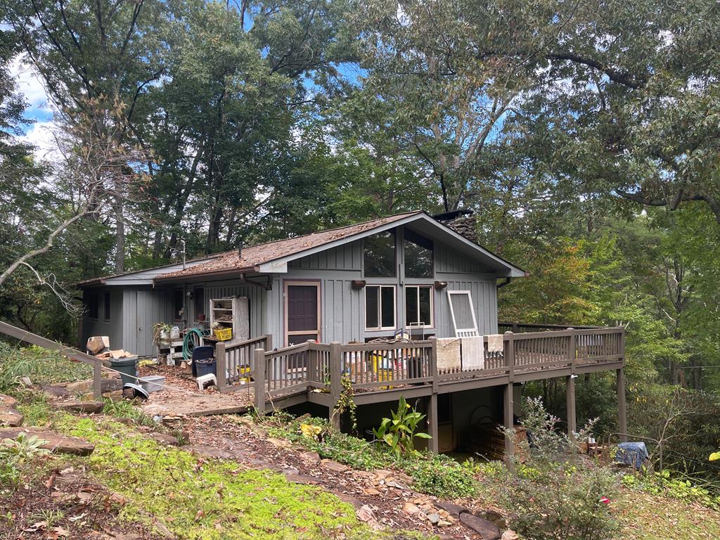 a front view of a house with swimming pool table and chairs