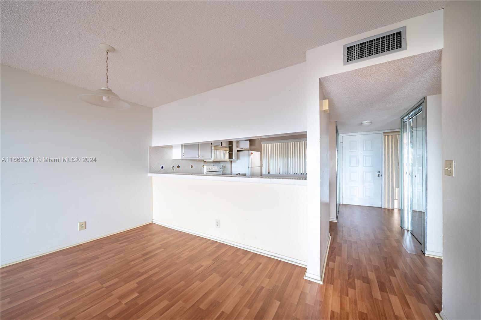 a view of a kitchen with wooden floor and a kitchen