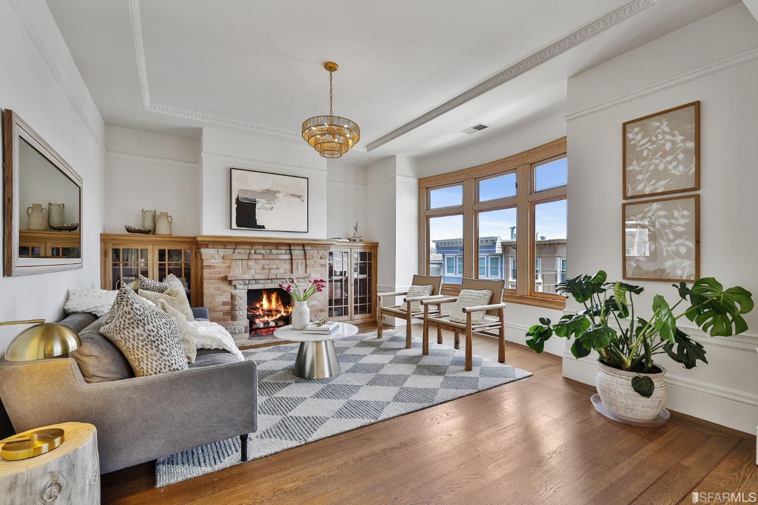 a living room with furniture fireplace and potted plants