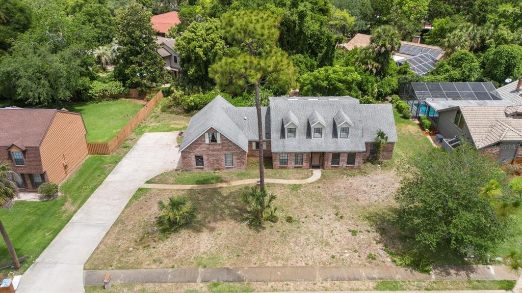 an aerial view of a house with a yard