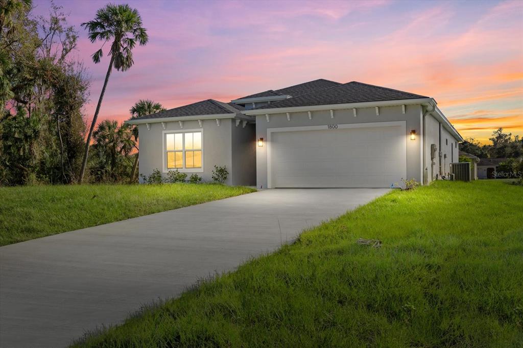 a front view of a house with yard and green space