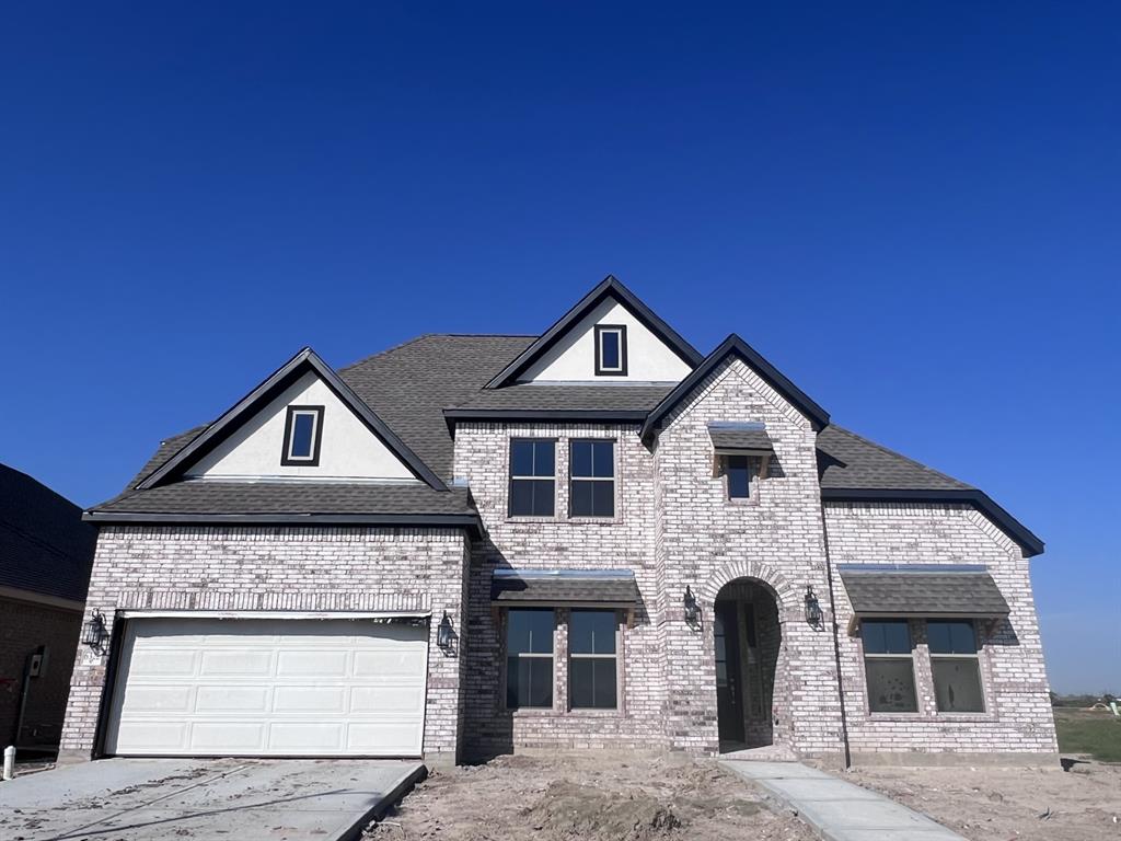 a front view of a house with a garage