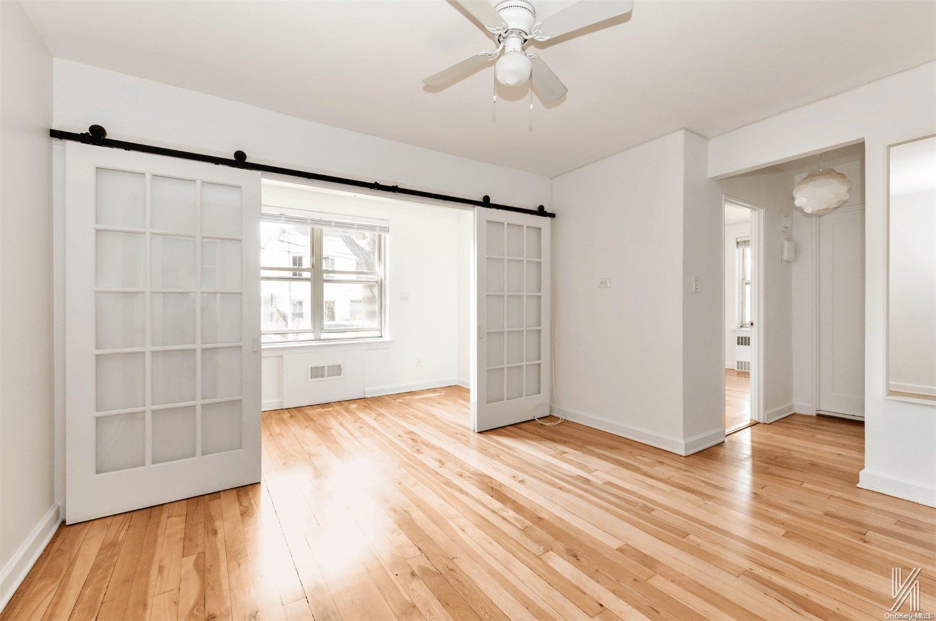 wooden floor in an empty room with a window