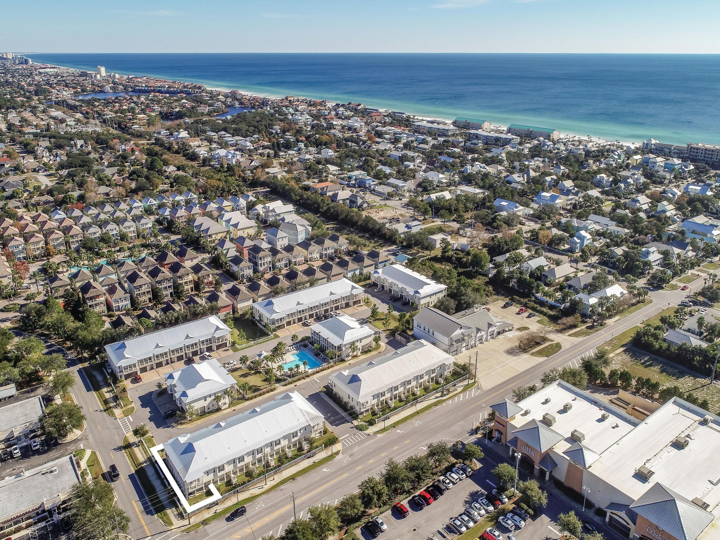 an aerial view of a city with ocean view