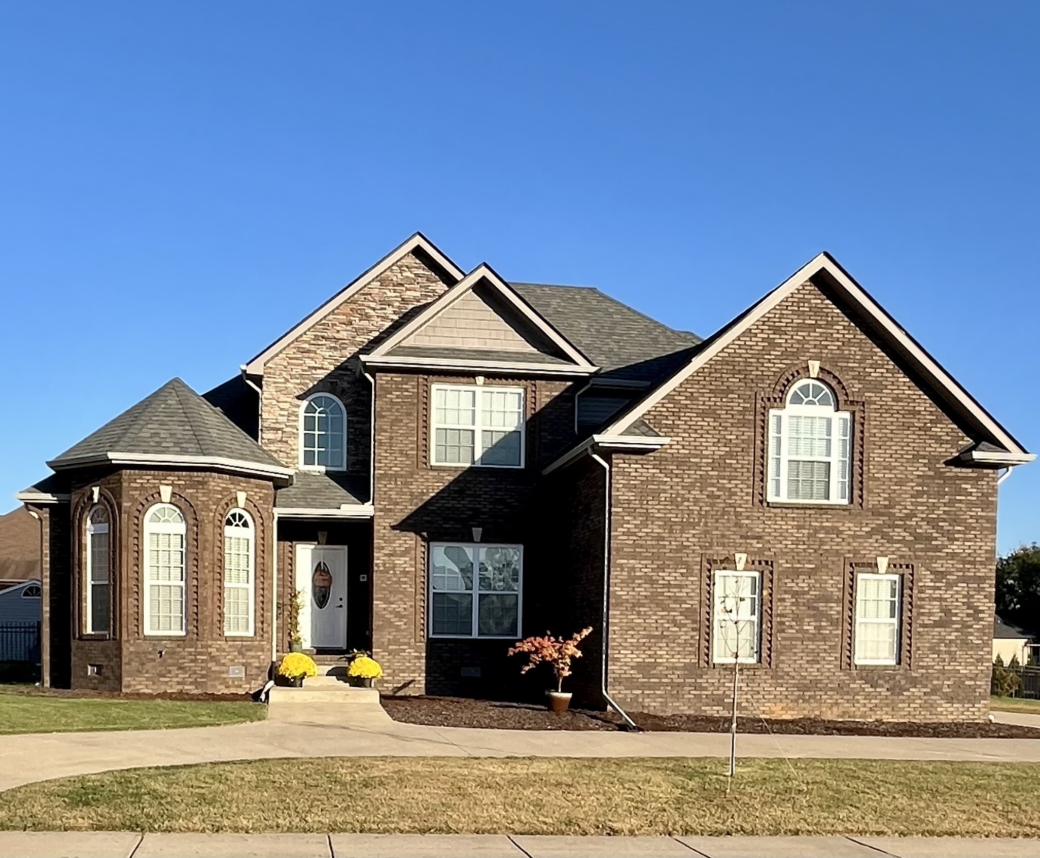 a front view of a house with a yard