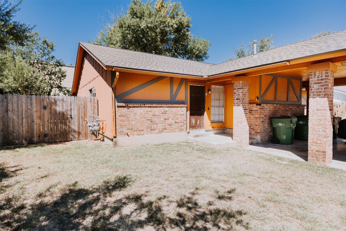 a backyard of a house with barbeque oven and wooden floor