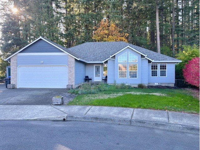 a front view of a house with a yard and a garage