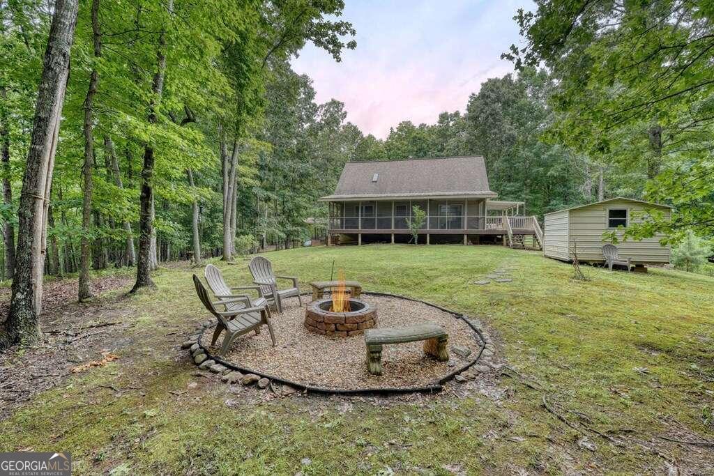 a view of a backyard with table and chairs