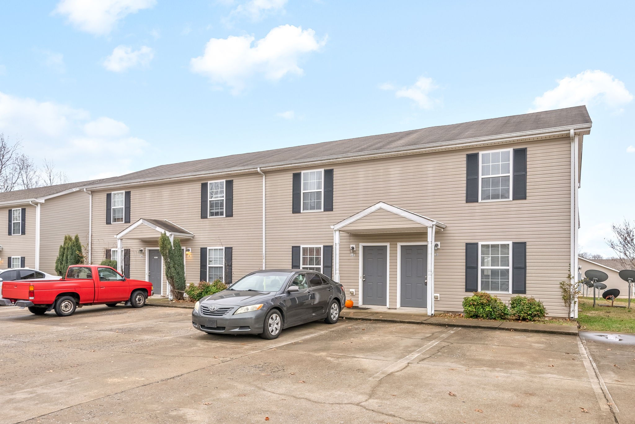 a front view of a house with parking space and a garage