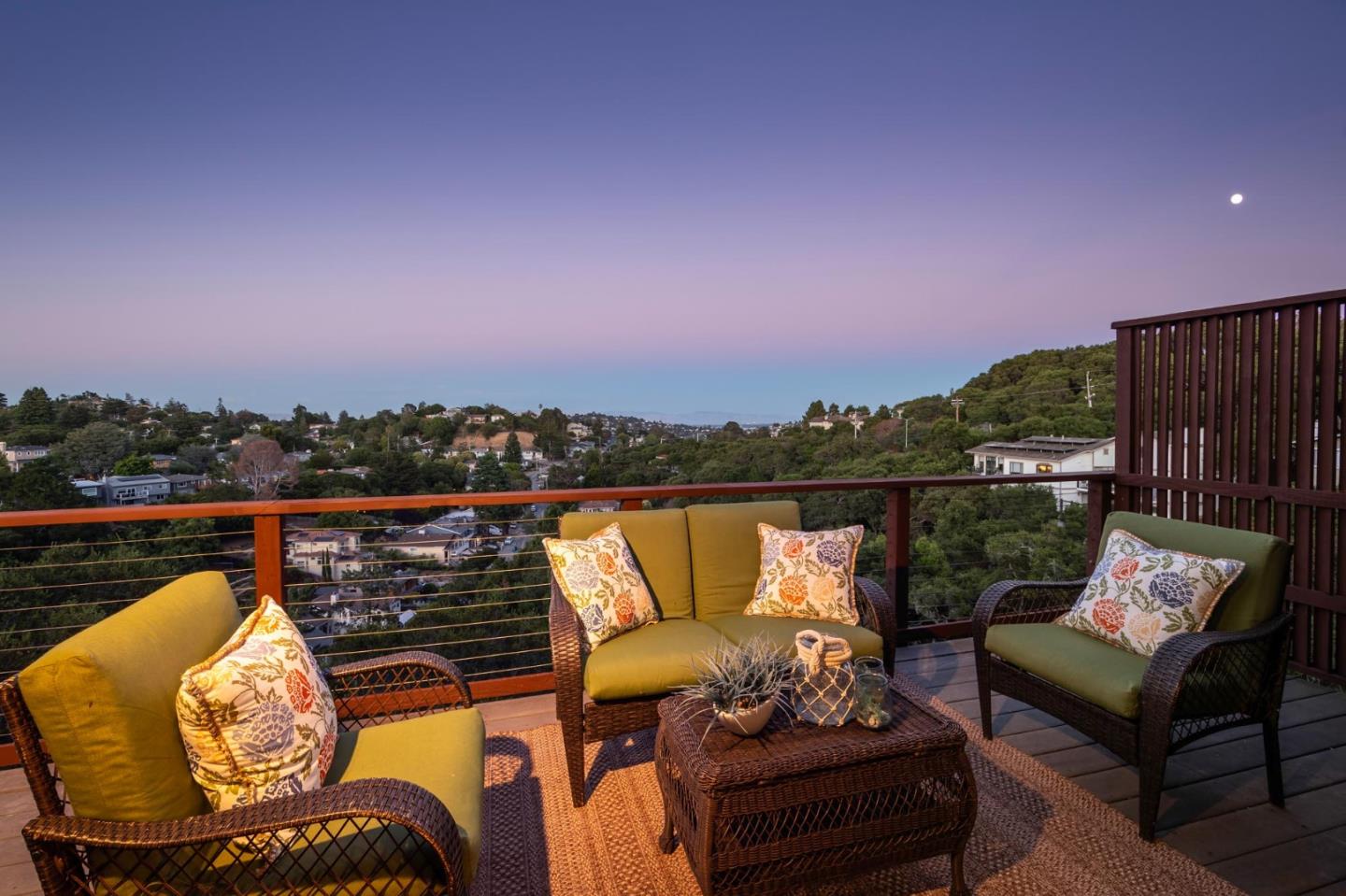 a balcony with wooden floor and city view