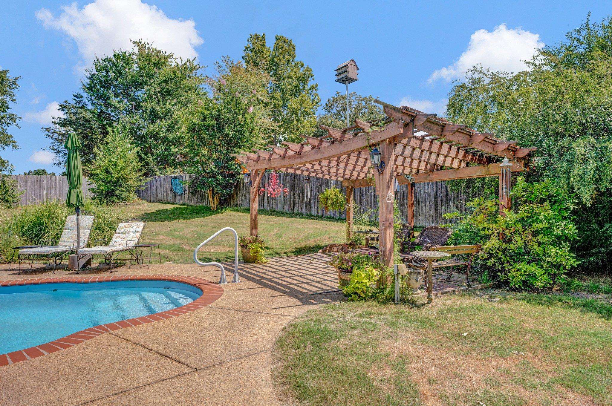 a view of a house with swimming pool and sitting area