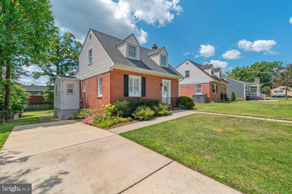 a front view of house with yard and green space