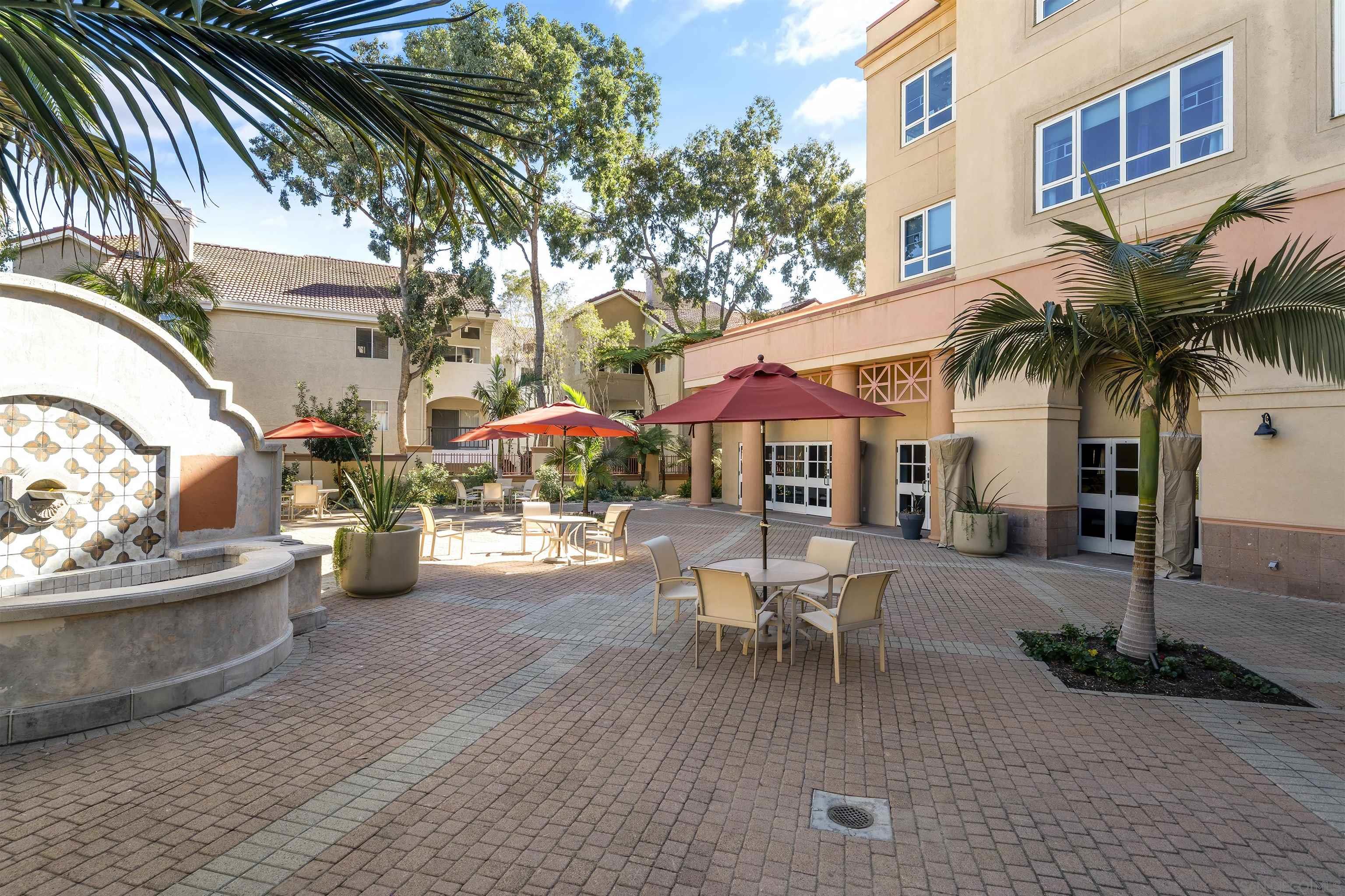 a view of a patio with couches and a fire pit