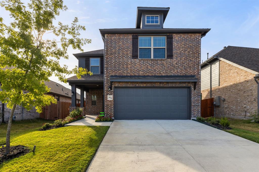 a front view of a house with a yard garage and outdoor seating