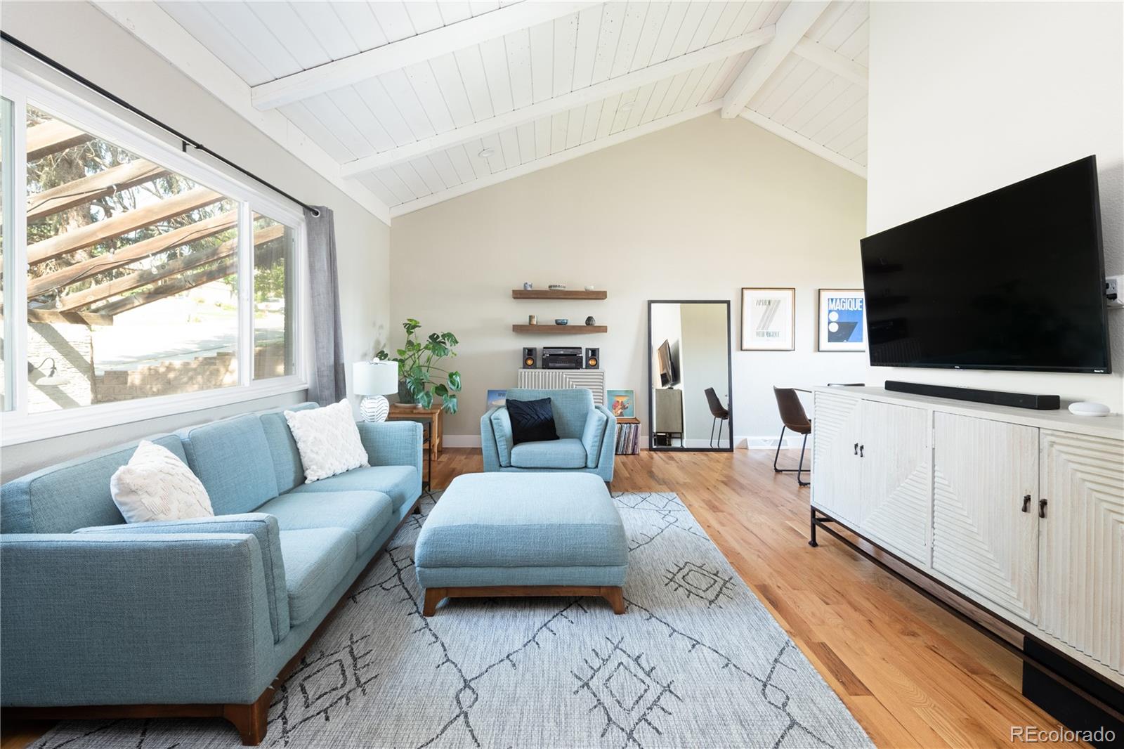 a living room with furniture and a flat screen tv