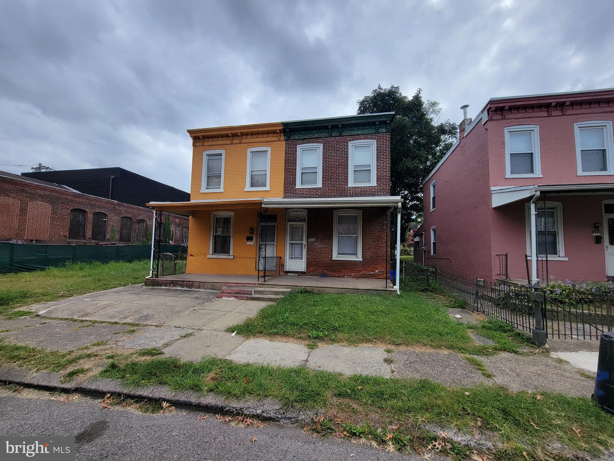 a front view of a house with a garden and yard