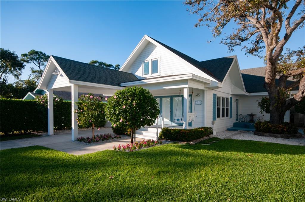 Front elevation. Take note of French door entry and charming porch swing